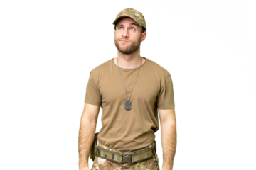 Military with dog tag over isolated chroma key background and looking up