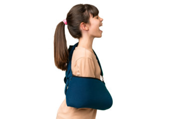 Little caucasian girl with broken arm and wearing a sling over isolated background laughing in lateral position