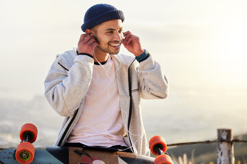 Skateboarder, earphones and man listening to music, audio or podcast online and relax after skating...