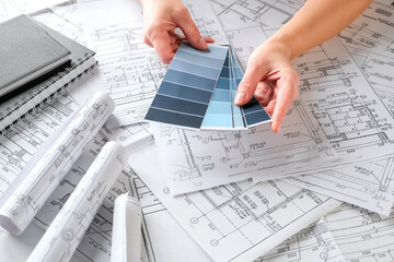 Architects concept, engineer architect designer freelance work on start-up project drawing, construction plan architect design working drawing sketch plans blueprints and making construction model