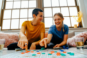 Young women playing board game. Bonding and Happiness at the Table