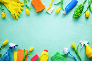 Flat lay composition with cleaning supplies, tools and spring flowers on colorful background - Powered by Adobe