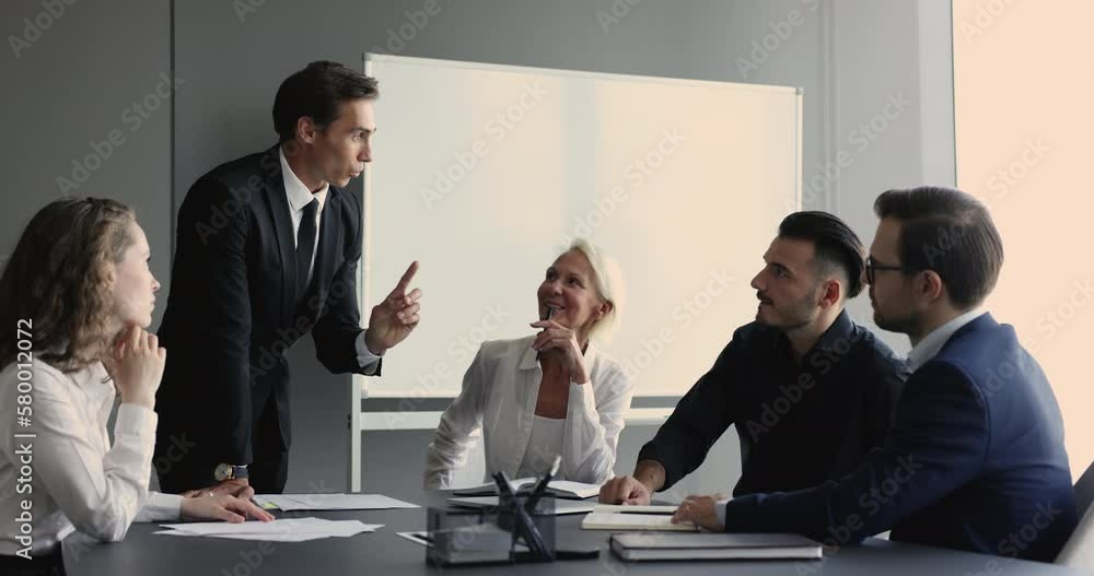 Sticker Confident businessman in suit lead negotiations, discussing project, commercial deal or contract details with clients, business partners or teammates gathered in office board room. Seminar, training