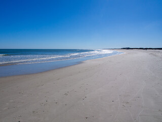 Stunning sandy beach on the Atlantic coast in South Carolina, USA, with clear, blue sky.
