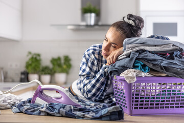 Wife fell asleep on a pile of clothes in the basket keeping the iron on next to her