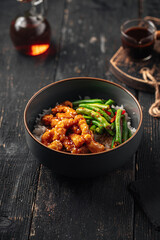 Portion of asian rice dish with chicken and green beans