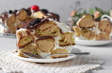 Profiterole Cake, cut into portions, one piece in the foreground