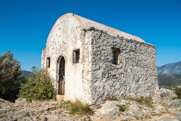 Fototapeta na wymiar Ruined hilltop chapel at Kayakoy (Levissi) abandoned village near Fethiye in Mugla province of Turkey.