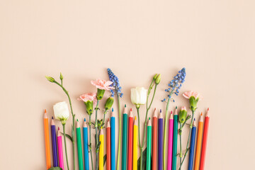 Color pencils with flowers. PANTONE peach fuzz. Color of the 2024 .. Summer school holidays concept. International children’s day background. copy space for text. 