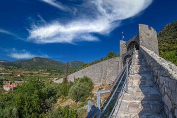 View of the medieval fortifications of the defensive wall, Ston, Dubrovnik area, Croatia - 580033009