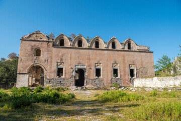 Fototapeta na wymiar Ruined Taksiyarhis upper church of Kayakoy (Levissi) abandoned village near Fethiye in Mugla province of Turkey.