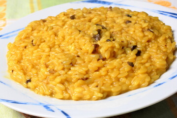Delicious dish of risotto with saffron and mushrooms.
