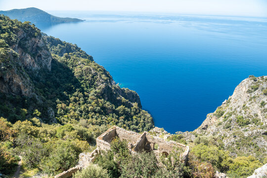 Mediterranean coastline near Kayakoy village in Mugla province of Turkey, with ruins of Afkule monastery.