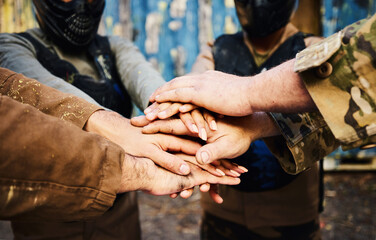 Motivation, team building or hands in huddle on a mission, strategy or soldier training on paintball battlefield. War goals, collaboration or army people with support in partnership or military group - obrazy, fototapety, plakaty