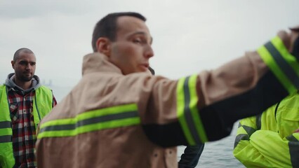 a group of volunteers searching for a missing person briefing on the ocean close up