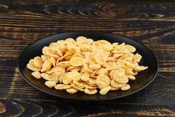 Cornflakes in a black plate