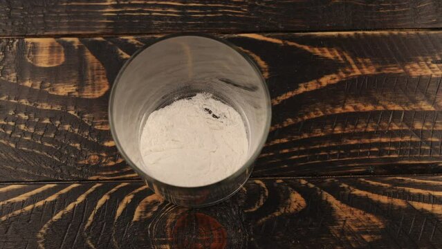 Protein powder is added to a glass