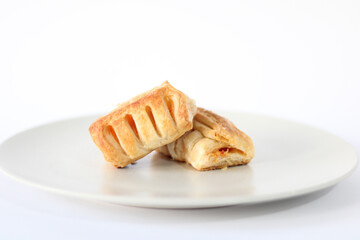 Bakery pastries with ham and cheese close-up. The concept of a delicious breakfast. Isolated over white background