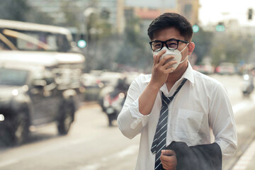 Business man wearing a mask on the street. Protection against air pollution and dust particles exceeds safety limits.PM2.5 unhealthy air pollution dust smoke in the urban city, PM 2.5