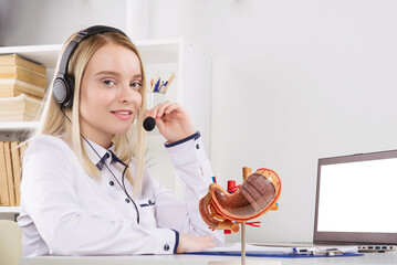 Portrait of happy smiling female customer support phone operator at workplace. mockup stomach on...