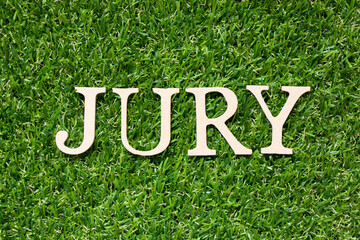 Wood alphabet letter in word jury on artificial green grass background - obrazy, fototapety, plakaty