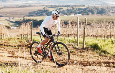 Man, bike and cycling on gravel in nature, countryside and training of triathlon, sports and power....