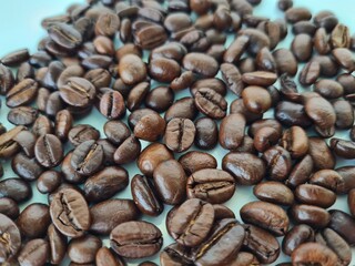 Closeup of fresh roasted coffee beans isolated on white background