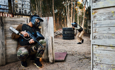 Sports, paintball and man with gun for battle, game or competition outdoors on field. War, military...
