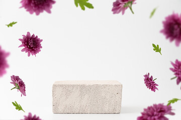Concrete stone podium background with flying pink flowers. Stand mockup for cosmetic products