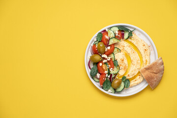 Hummus salad in plate on light background with copy space. Healthy food. Dip plate appetizer with...