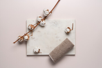 Fototapeta na wymiar Spa, beauty composition with cotton branch, stones, towel on light beige background with copy space. Body care concept, top view background