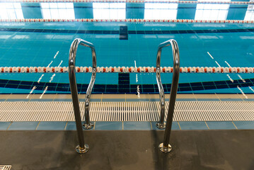 Swimming pool with dividing paths and handrails