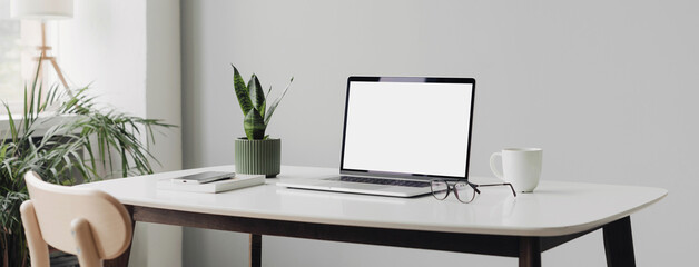 Laptop mockup, computer with empty blank white screen in modern interior. Home office desk, freelancer business, e-learning, web site and online shop template, technology concept. Banner