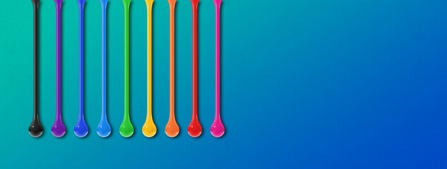 Colorful ink drops on blue background. Horizontal banner