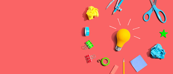 Idea light bulb with school supplies overhead view - flat lay