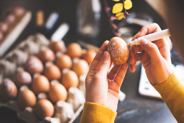 DIY hand painted easter eggs. Unrecognizable person hand painting easter eggs.