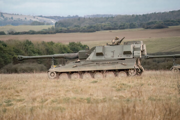 Fototapeta premium British army military AS90 (AS-90 Braveheart Gun Equipment 155mm L131) armoured self-propelled howitzer on a military exercise, Wilts UK