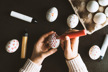 DIY hand painted easter eggs. Unrecognizable person hand painting easter eggs.