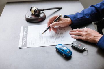 car auction concept Lawyer working at a table in a court of law The concept of selling a car by...