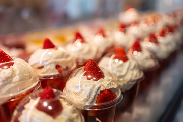 Strawberries with cream prepared in containers for individual consumption and exposed for sale, Mercado de San Miguel, Madrid.