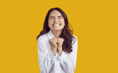 Portrait of excited joyful Caucasian woman who very much wants to get what she dreams of. Woman...