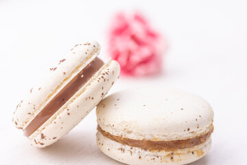 White creamy macarons on white background. Salted caramel macaroon. Traditional French dessert