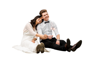 Happy wedding young couple sitting on the floor with sparklers on isolated png background