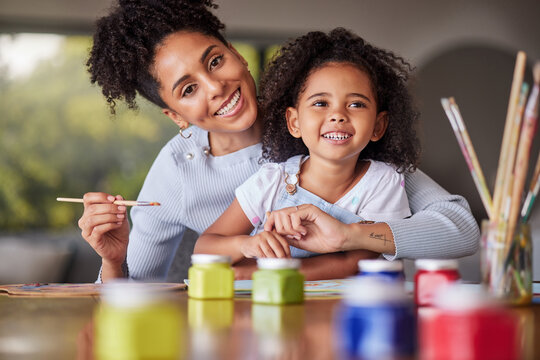 Painting, girl and mother bonding in creative art activity in home or house for school, learning and education project. Portrait, smile and happy Brazilian mom helping family child in fun color class