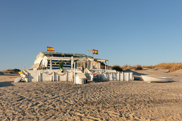 Fototapeta na wymiar Picturesque white wooden fisherman's house on the shore of the beach