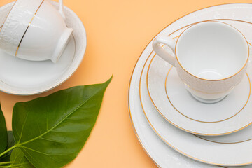 Porcelain tea cup with a golden line decoration and a saucer with clipping path. on colour background