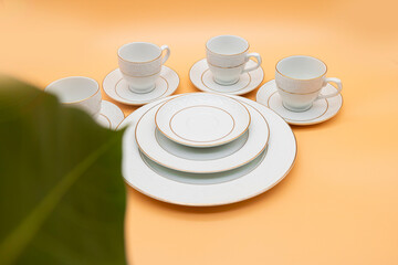 Porcelain tea cup with a golden line decoration and a saucer. On background. Ready to cut out
