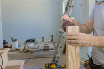 It is being worked on staircase grinder work timber wood railings in new house as work progresses