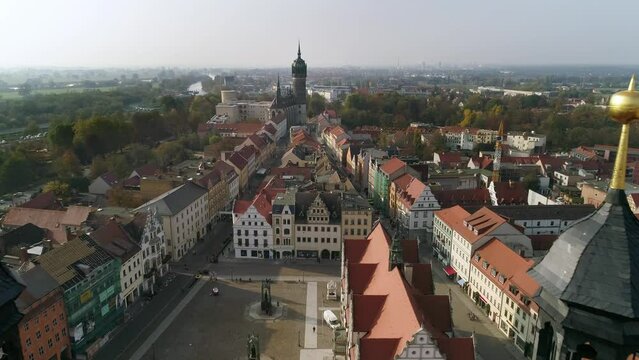 flight over the market square of wittenberg in the direction of the castle church and castle tower