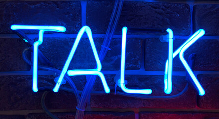 Neon sign that says the word Talk.